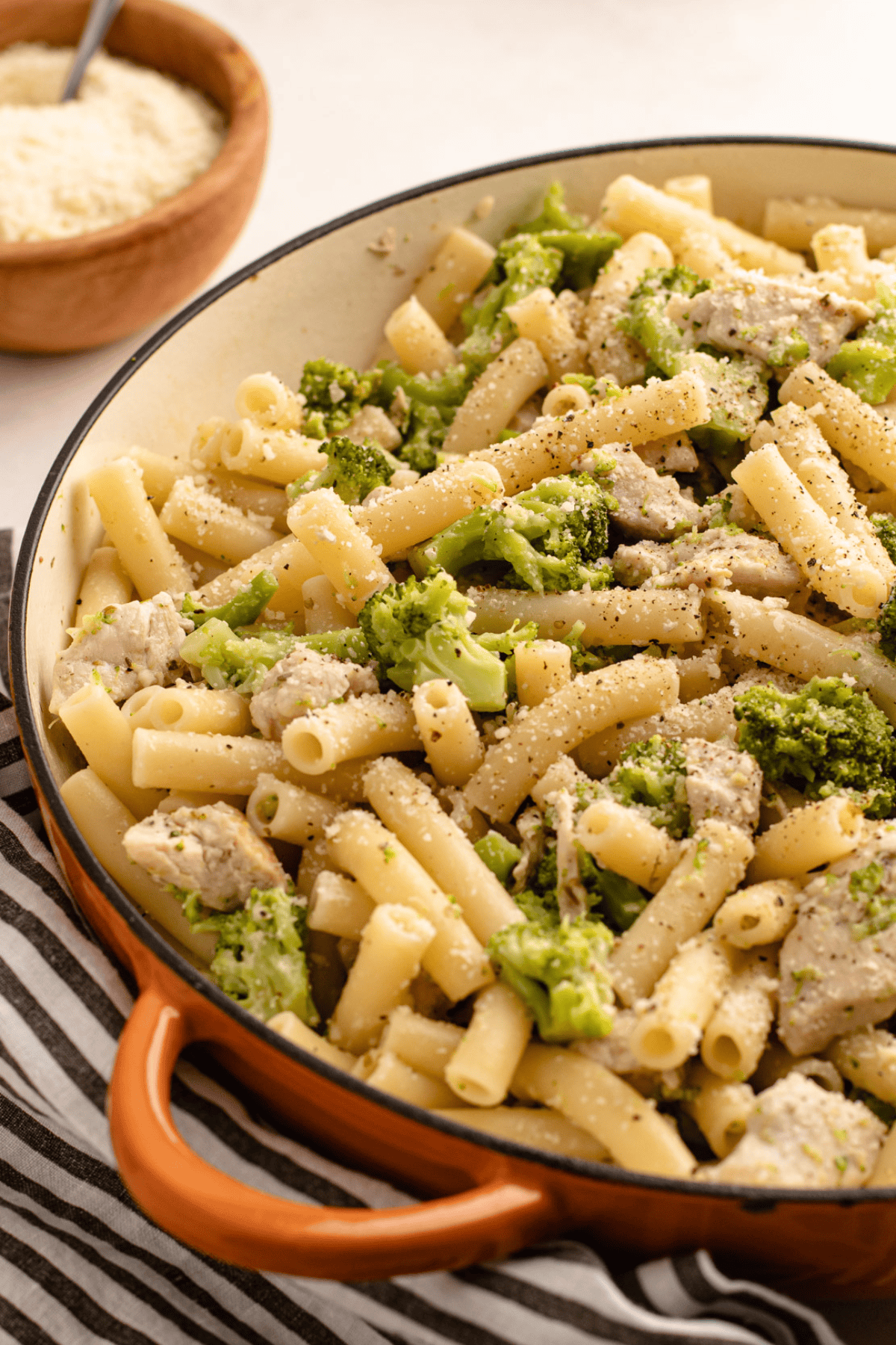 Cooked chicken broccoli and ziti in a skillet.