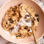 A bowl of cinnamon raisin oatmeal made on the stove.