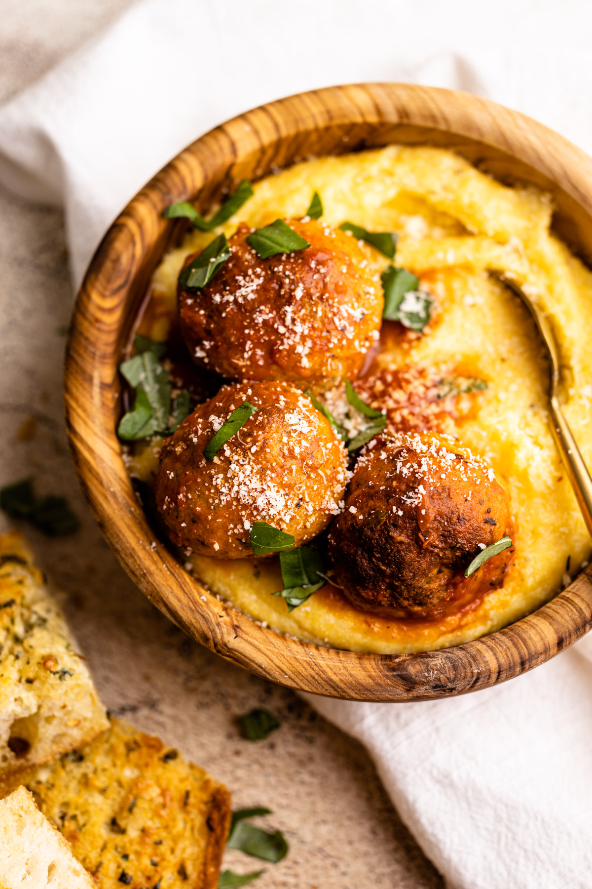 A bowl of meatballs with polenta.