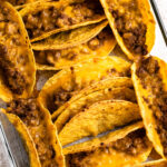 Oven tacos with beef and melty cheese.