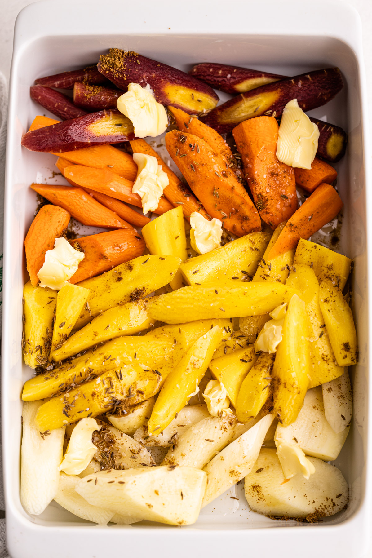 Carrots in a container for honey roasted carrots.