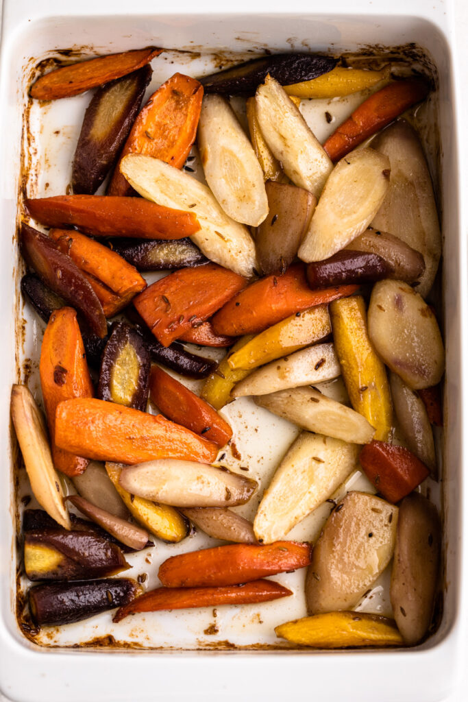 Roasted carrots in a baking container.