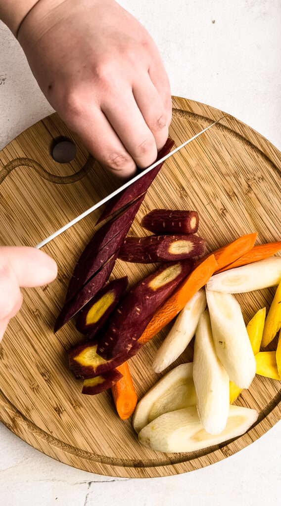 Cutting carrots for roasted carrots.