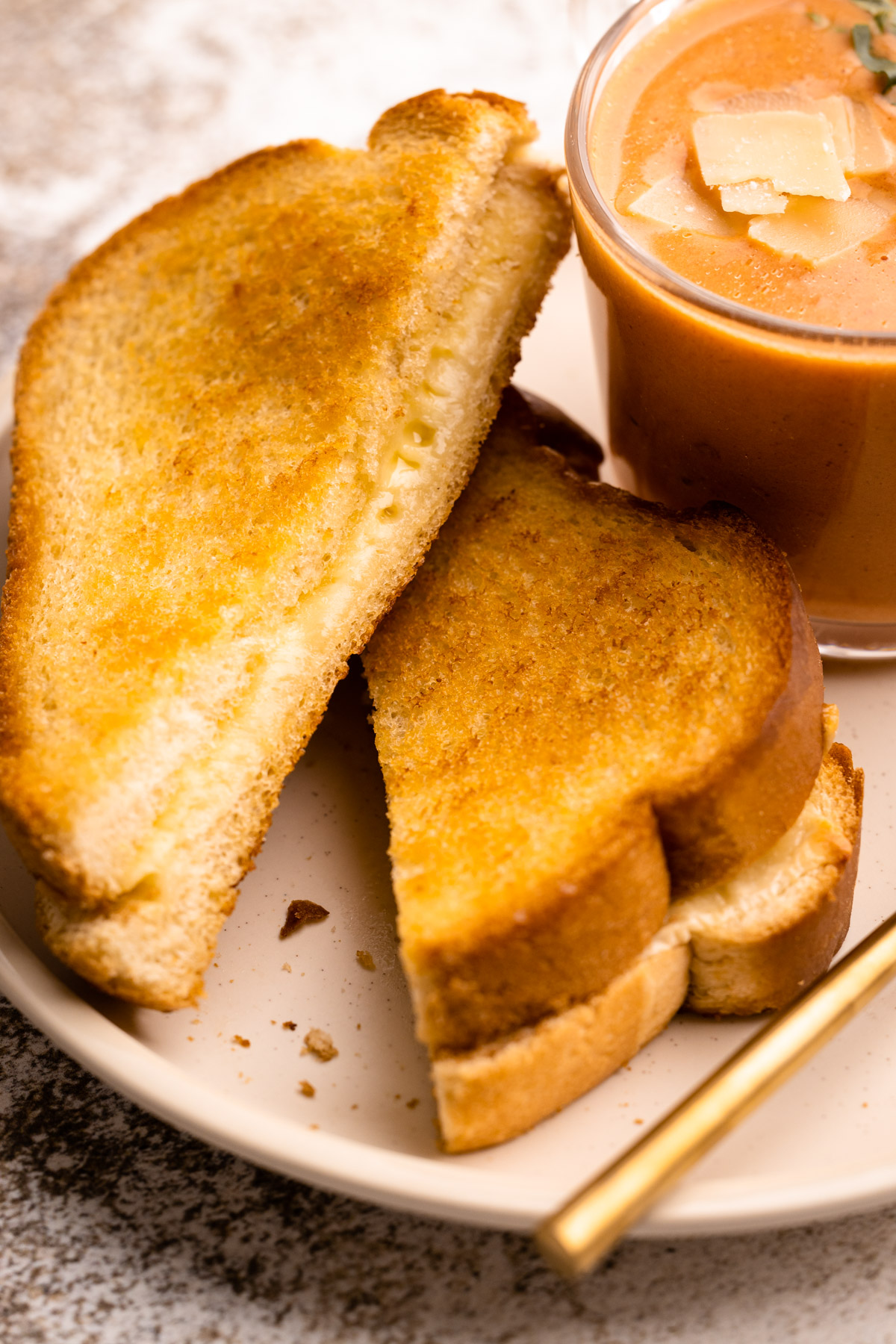 A plate of grilled cheese with tomato soup.