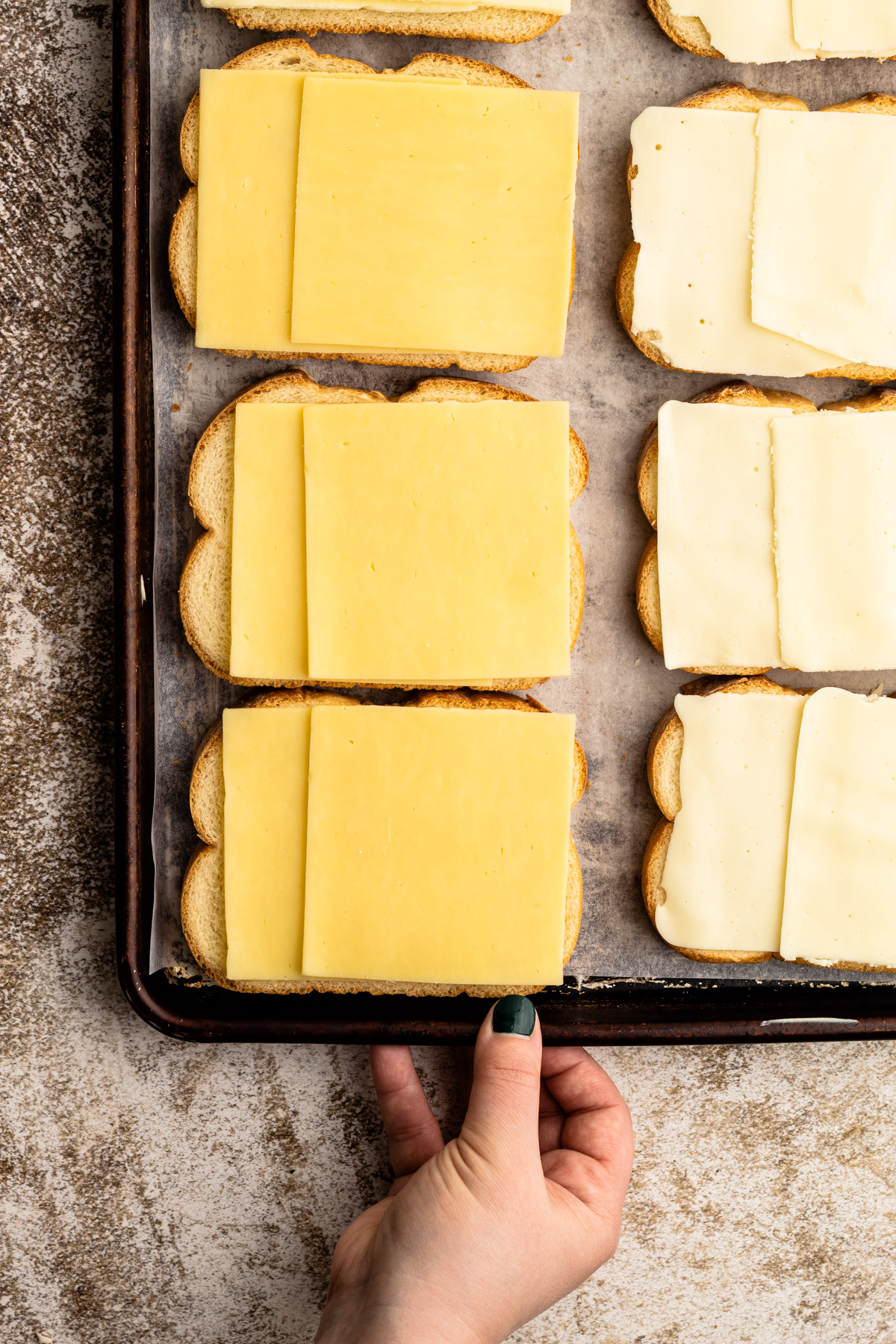 A sheet pan with grilled cheese on them.