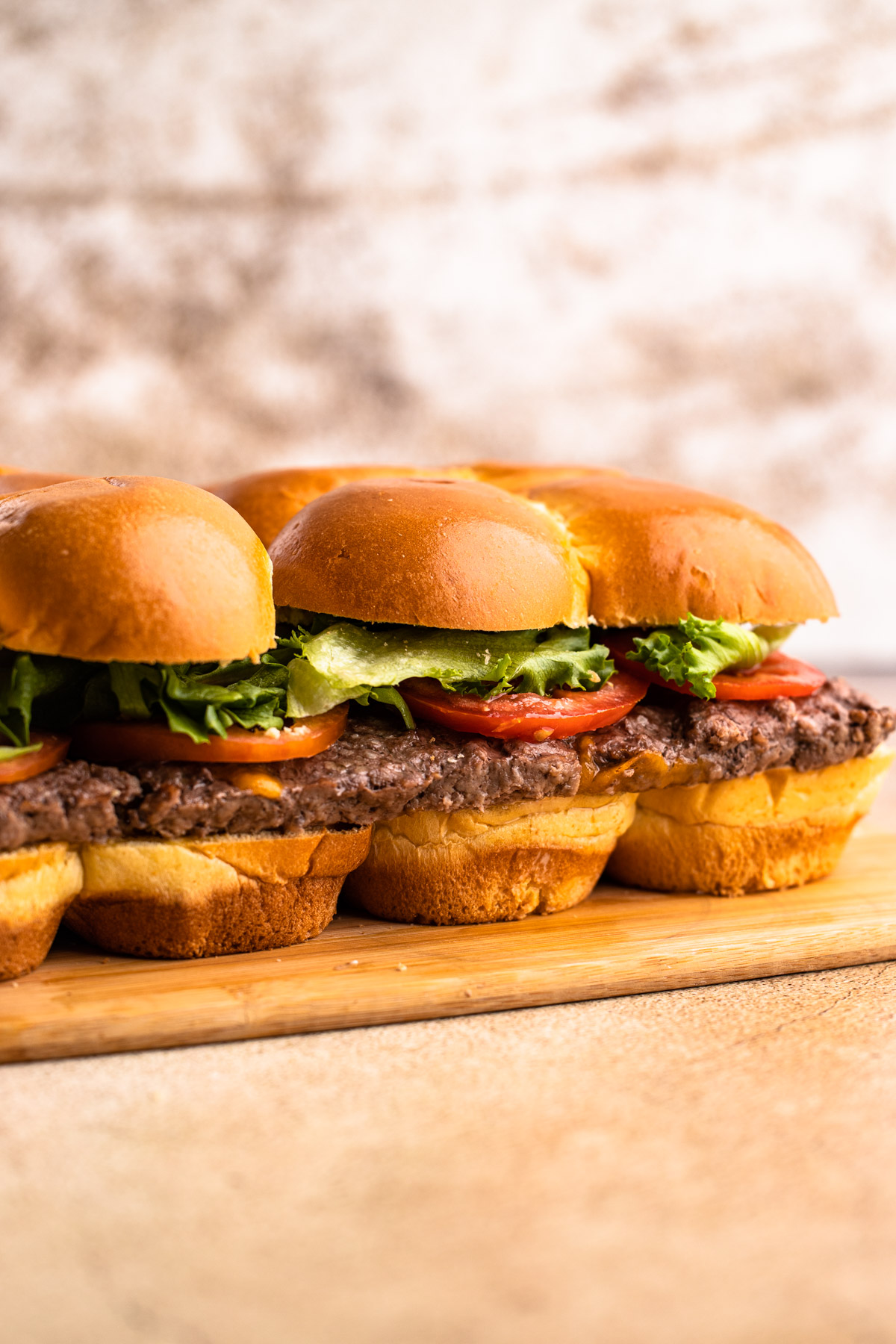 Sheet pan sliders with special sauce, lettuce and tomato.