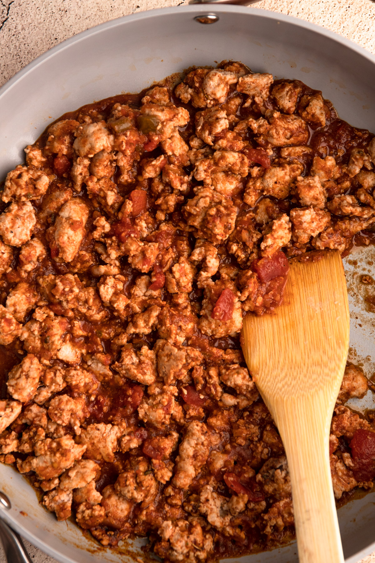 Ground turkey in a skillet with taco seasoning and salsa.