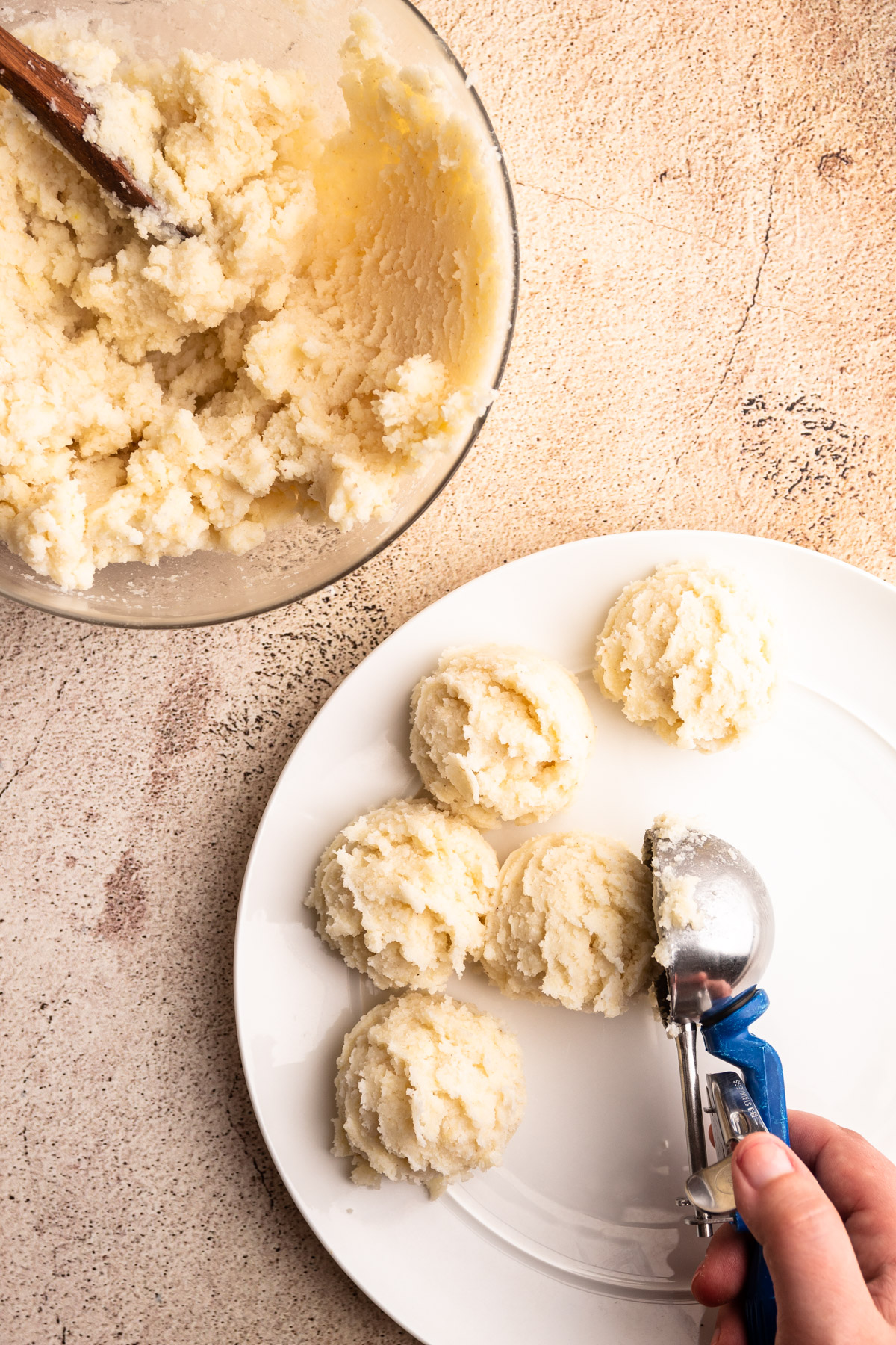 Scooping arepa dough.