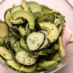 A bowl of cucumber avocado salad.