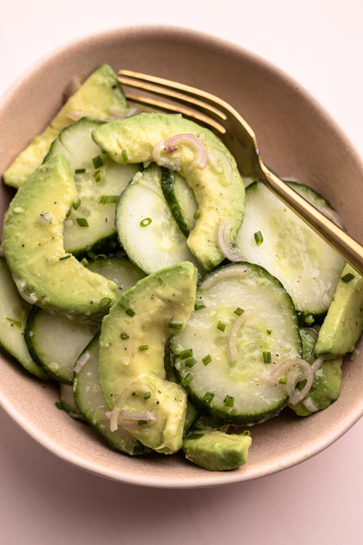 A serving size portion of cucumber avocado salad.