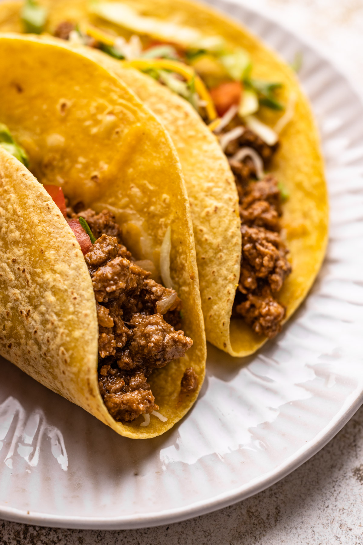 Two ground beef tacos made from beef taco filling.