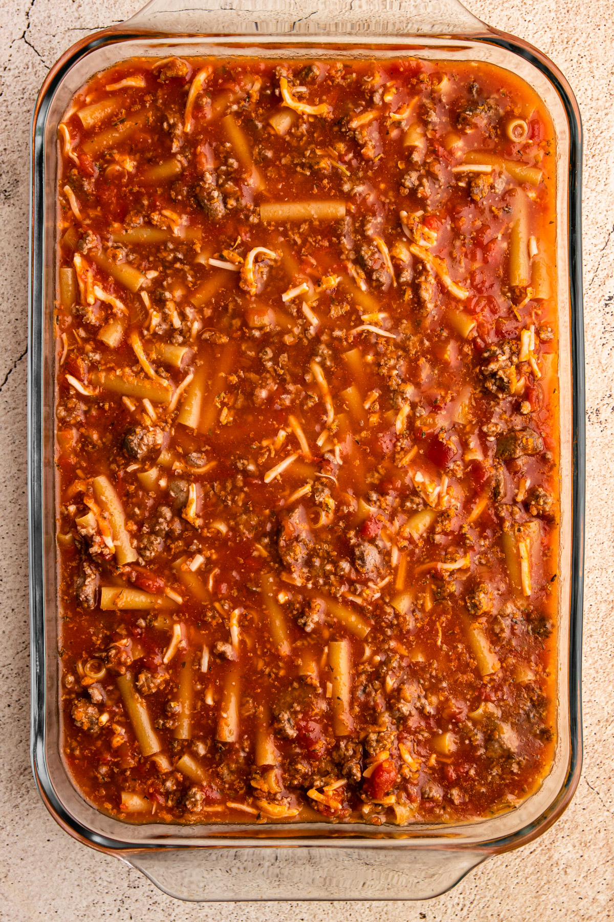 Baked ziti ingredients in a pan.