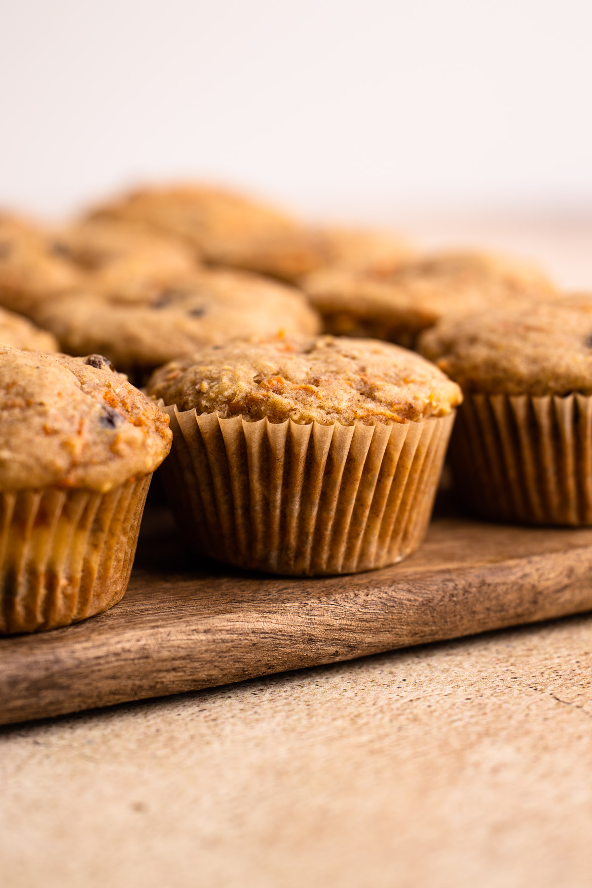 Carrot cake muffins on a cutting board.