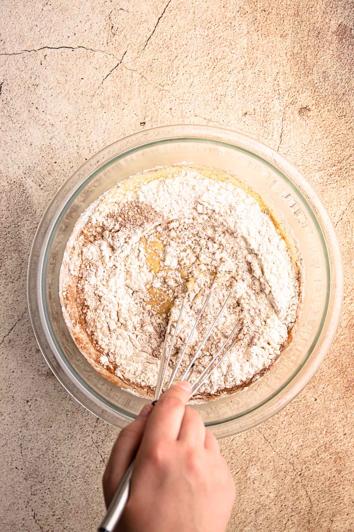 Carrot cake muffin ingredients in whisked together in a bowl.