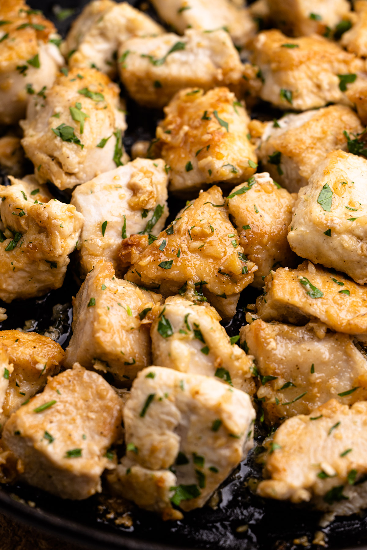 Garlic butter chicken bites in a skillet.