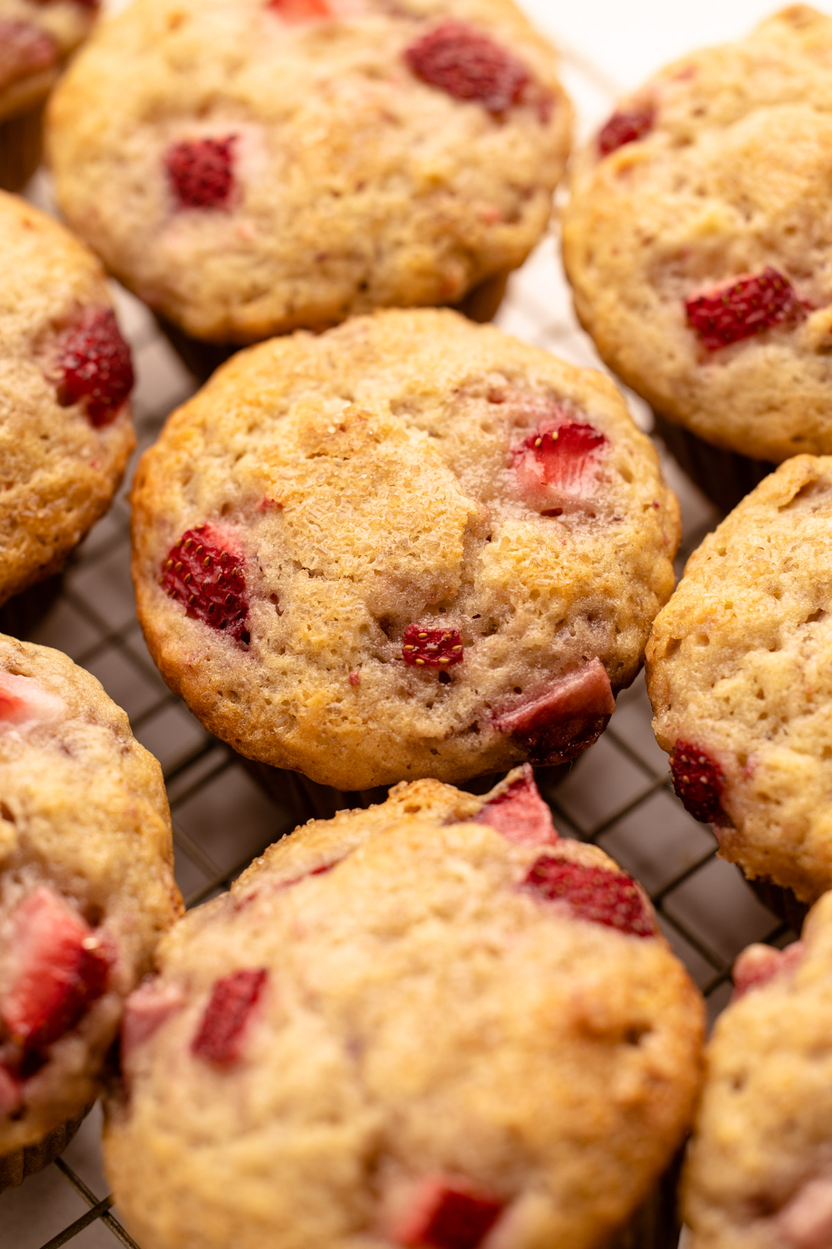 Buttermilk Strawberry Muffins on a cooling rack.