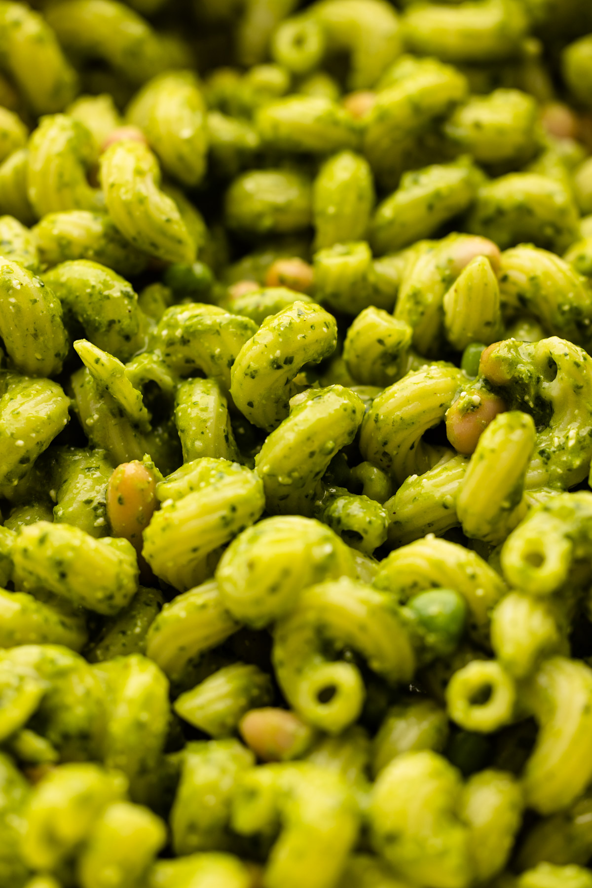 Kale pesto pasta with beans, peas and lemon.