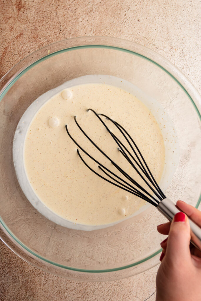 The dressing for creamy macaroni salad in a bowl.