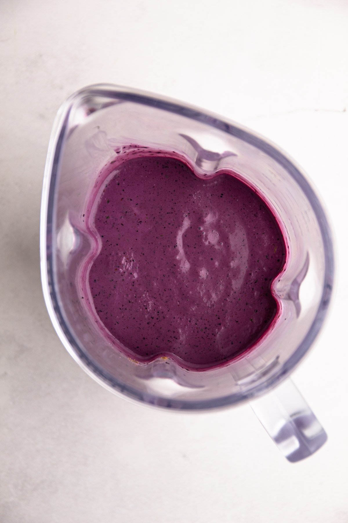 Blueberry breakfast popsicles mixture in a blender.