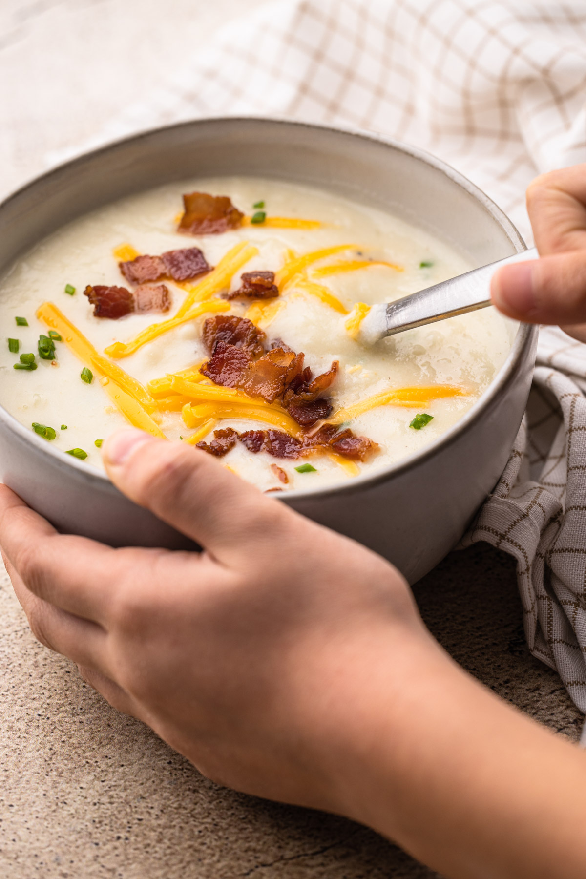 A bowl of potato soup with cauliflower.