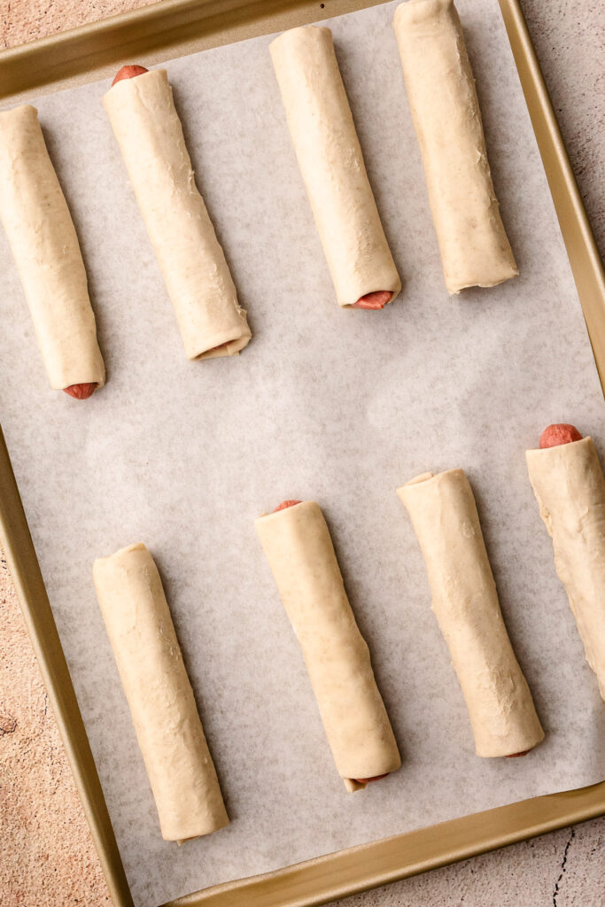 Unbaked puff pastry pigs in a blanket.