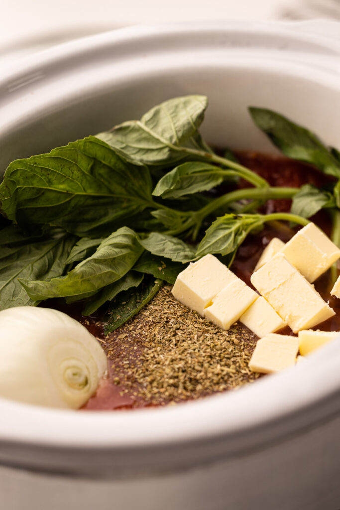 Ingredients for tomato sauce in a slow cooker.