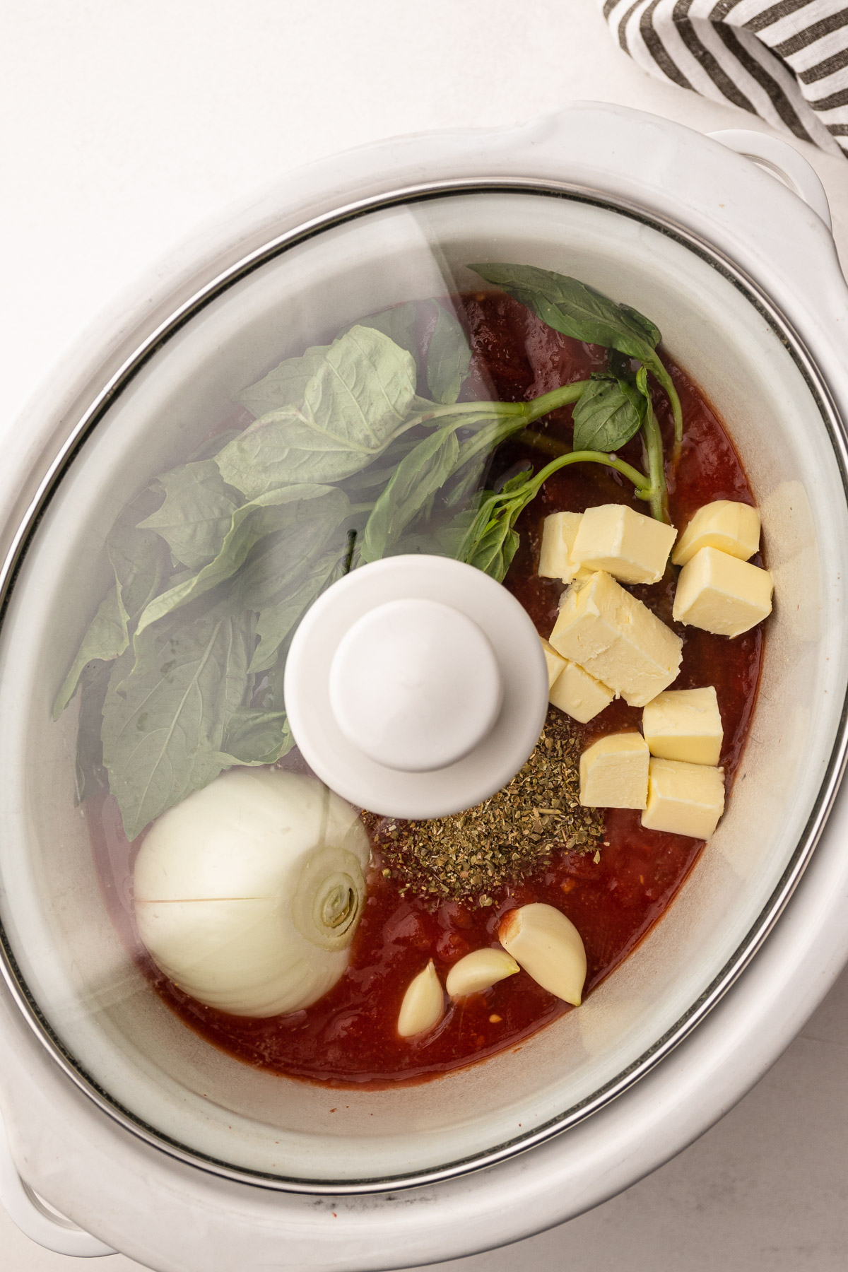 Ingredients for tomato sauce in a slow cooker.