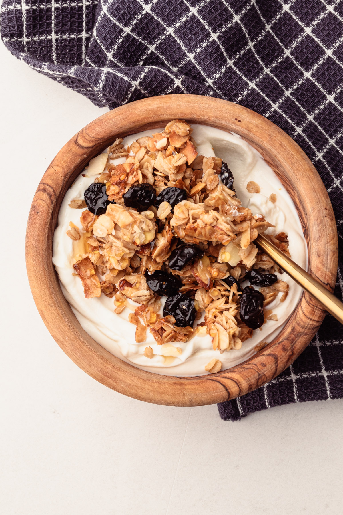 A bowl of almond cherry granola with yogurt.