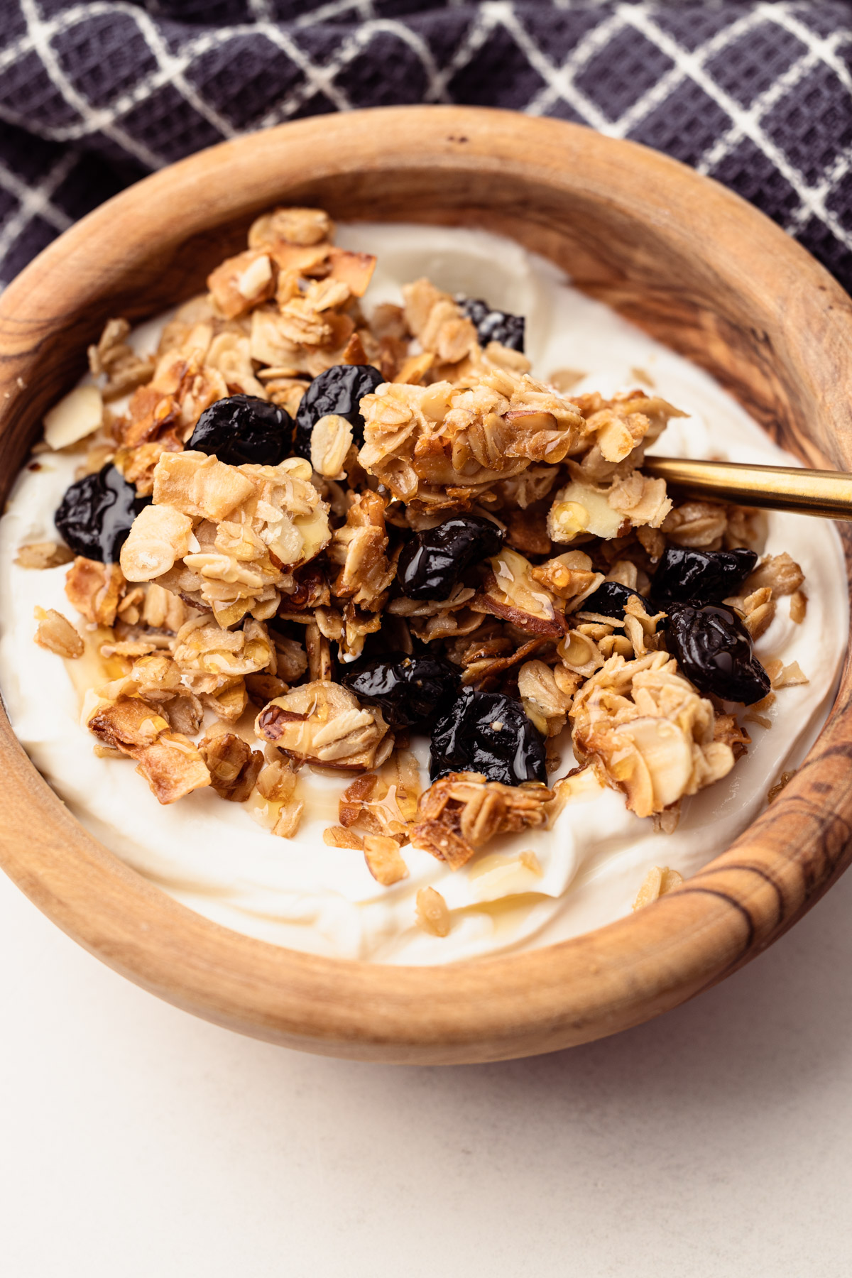 A bowl of almond cherry granola and yogurt.