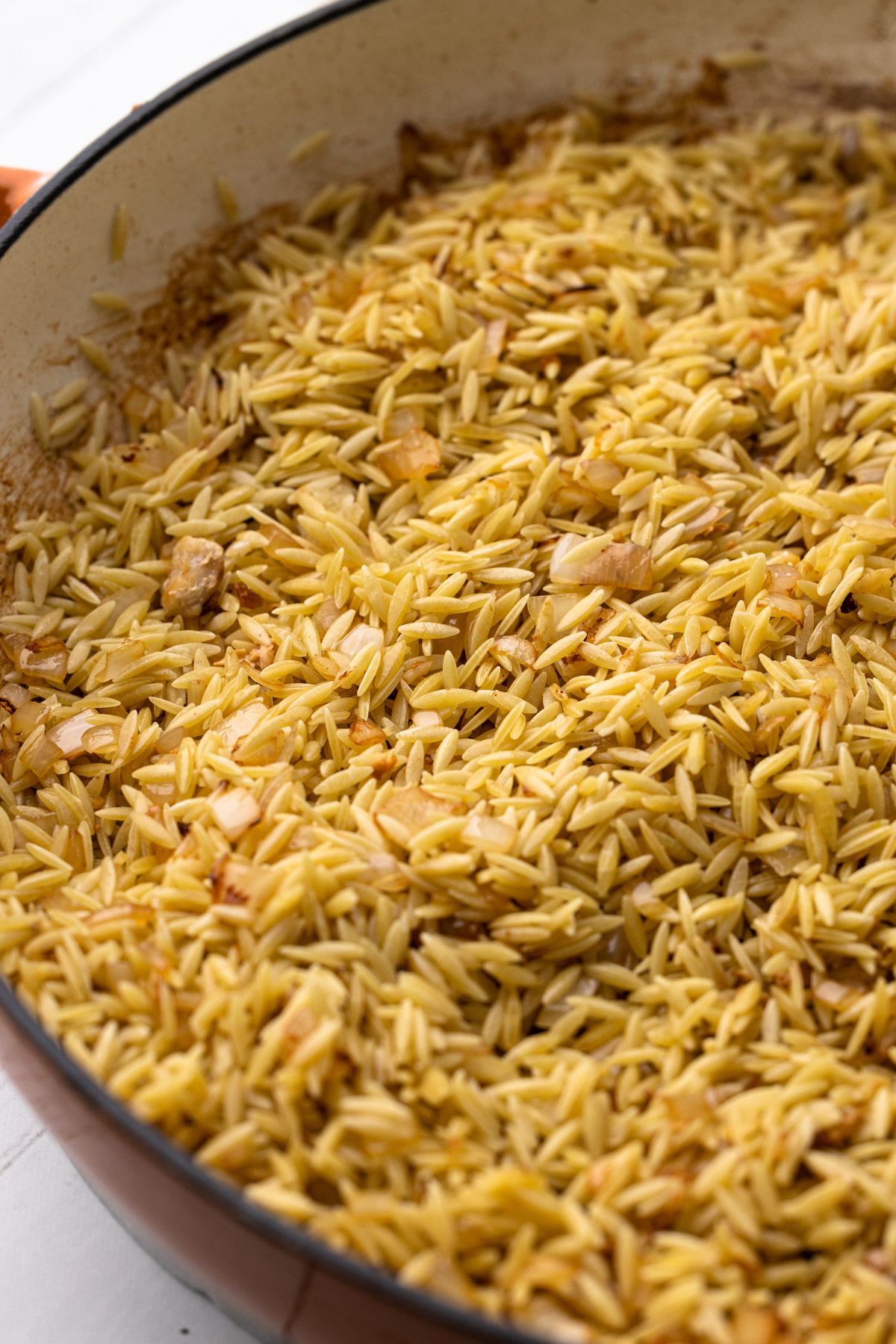 Making the orzo in the skillet.