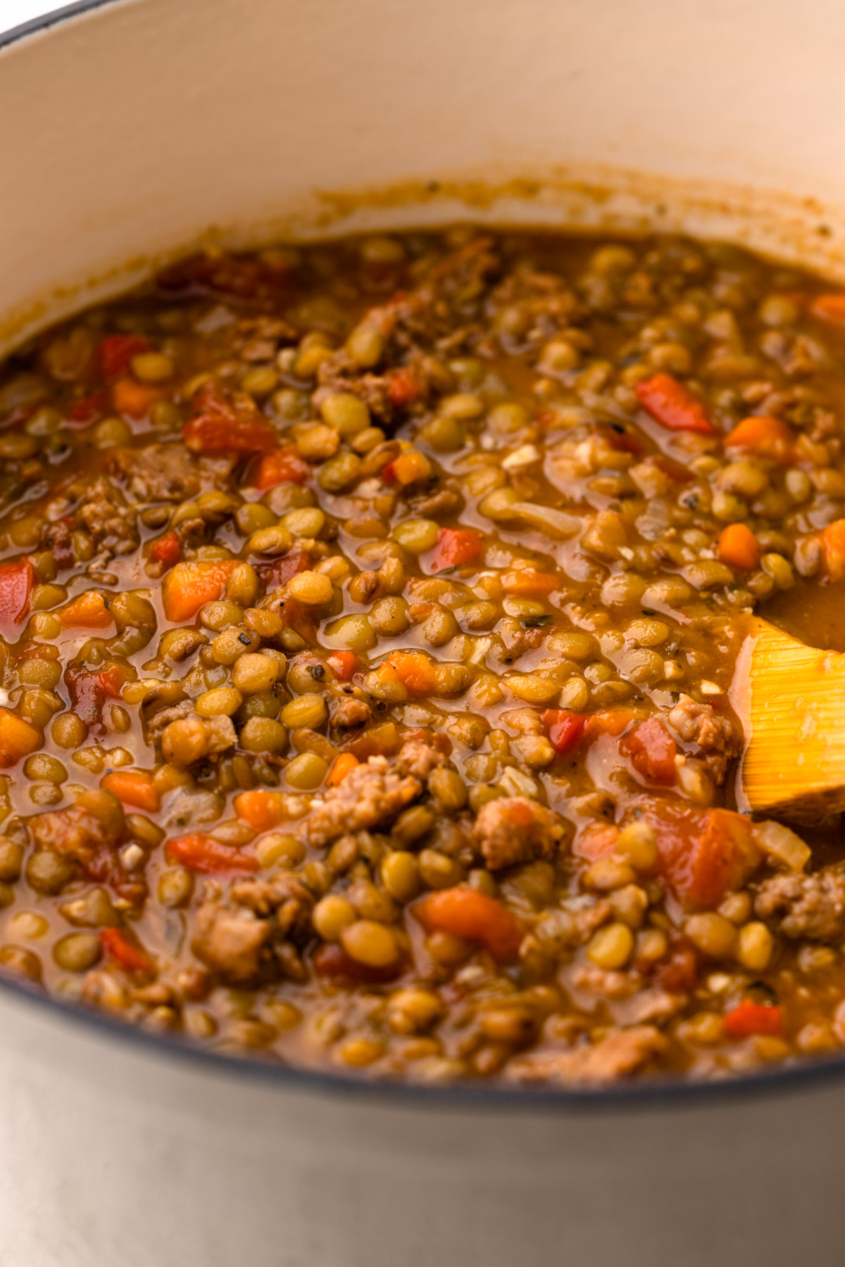 Lentil soup with sausage in a pot.