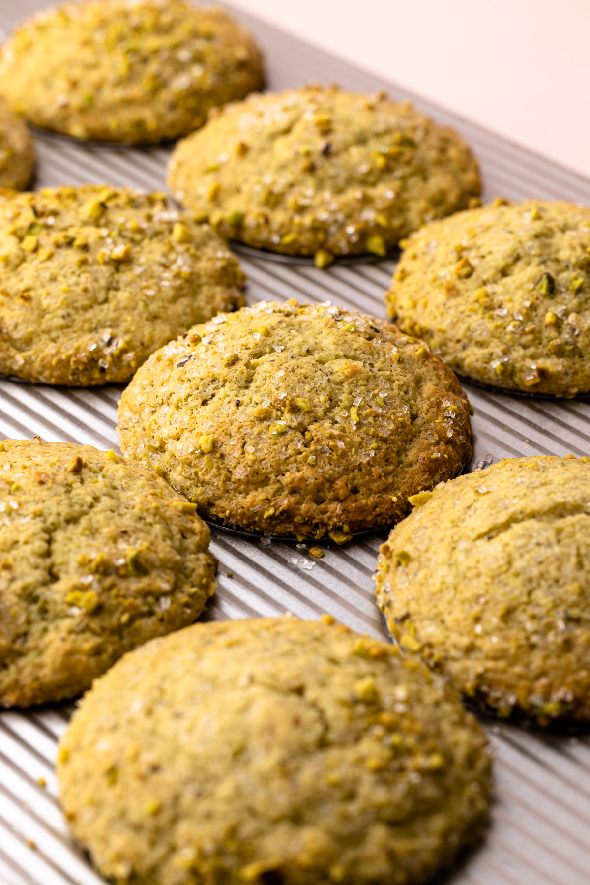 Pistachio Muffins in a muffin tin.