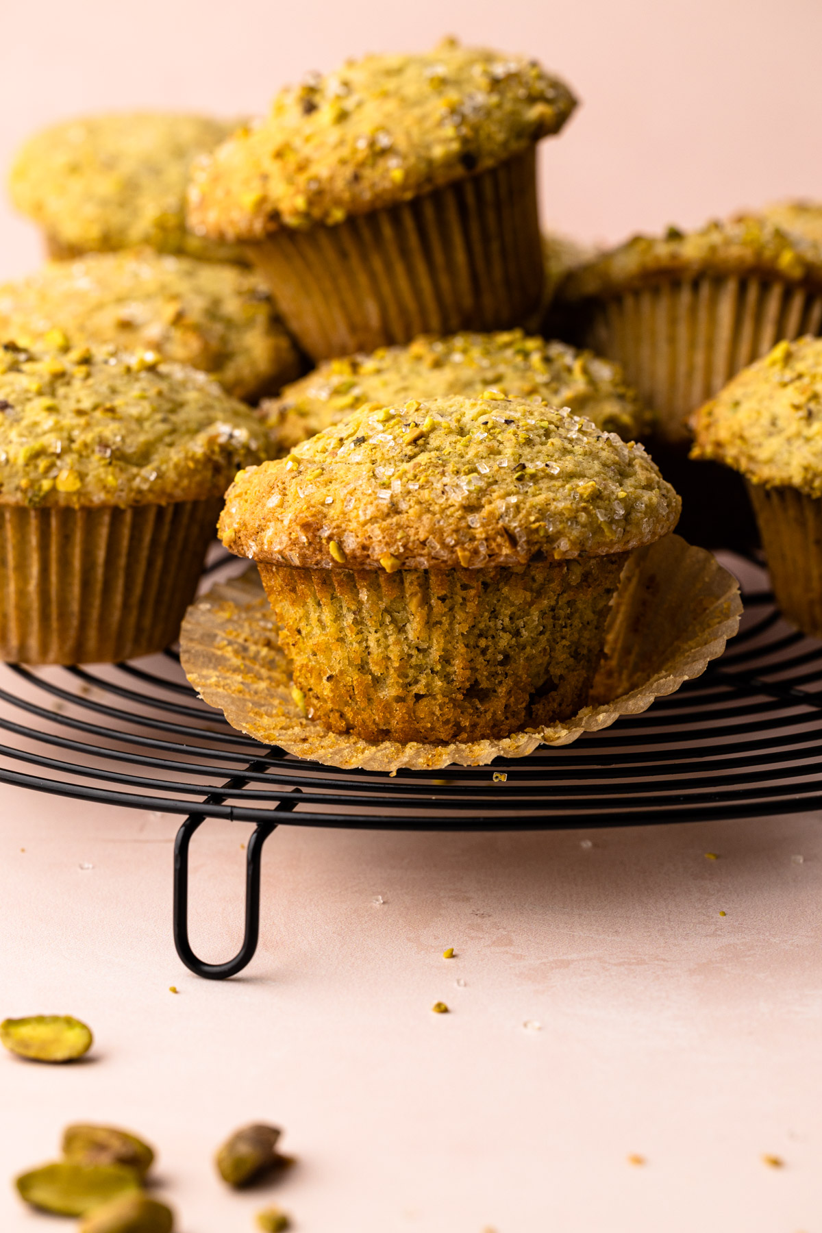 A pistachio muffin on a cooling rack.