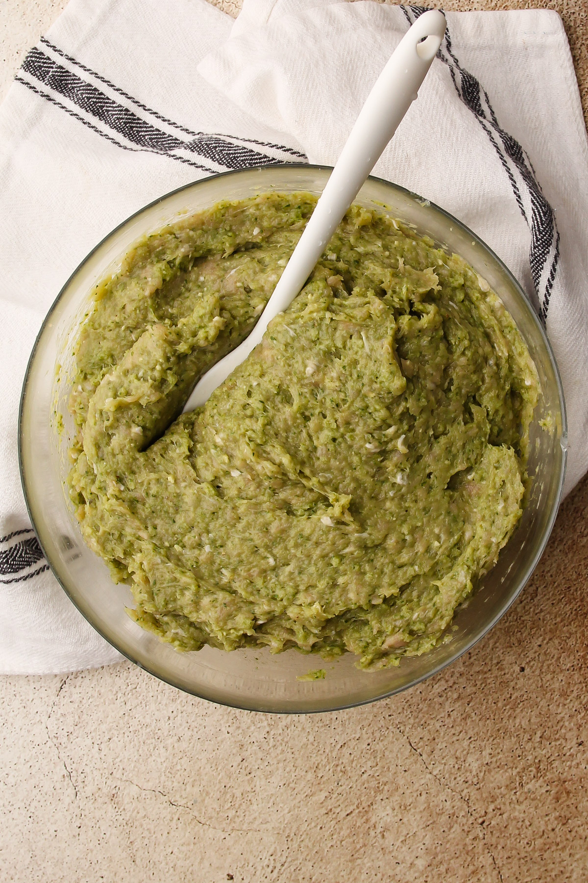 Raw pesto chicken meatballs in a bowl.