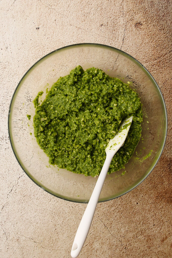 A mixture for pesto chicken meatballs.