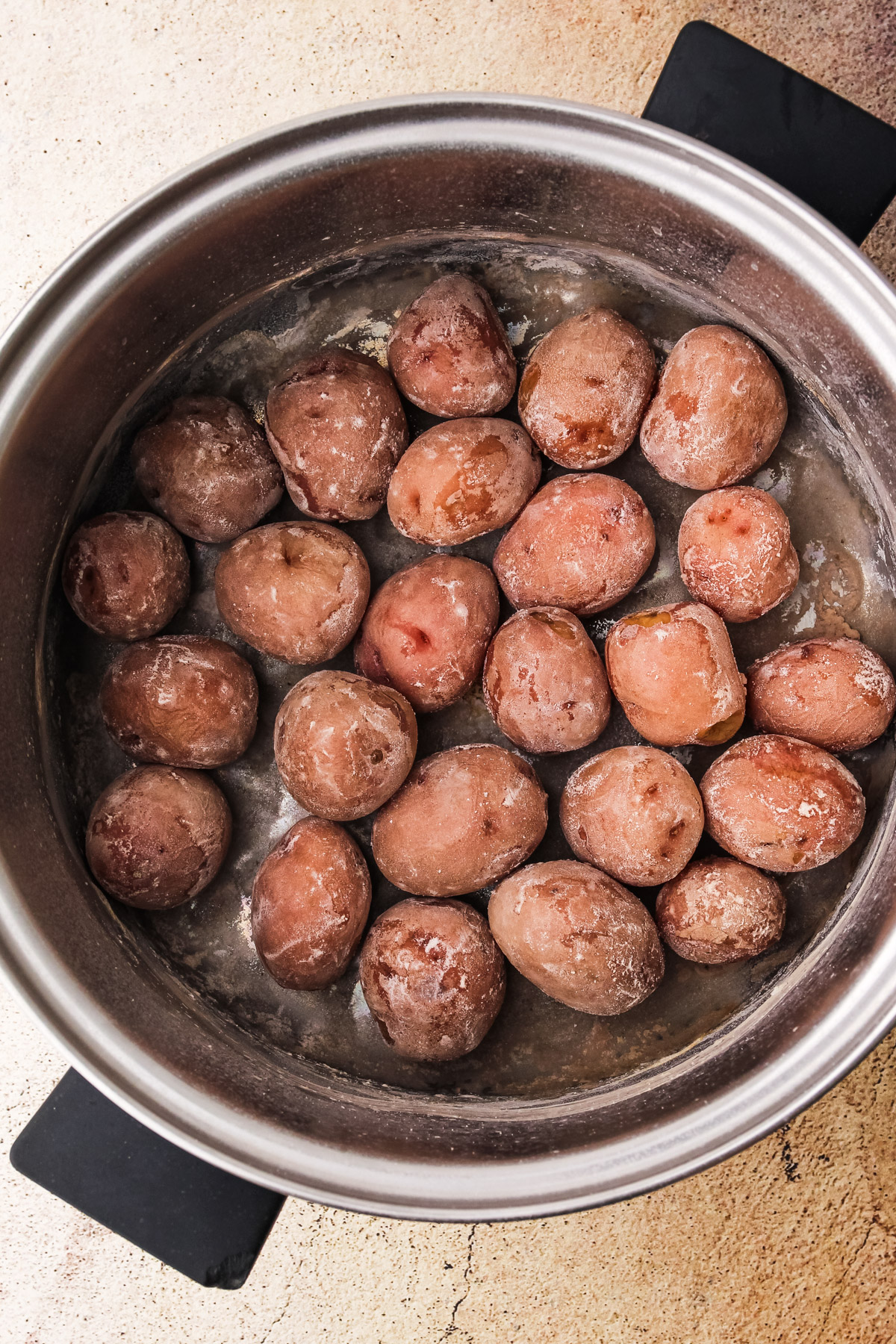 Salted potatoes fully cooked in a pot.