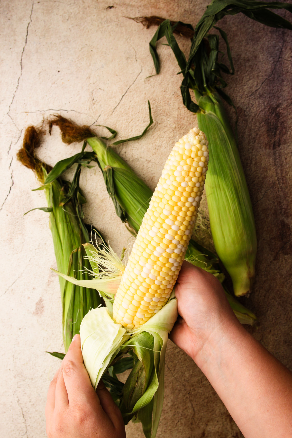 Shucking fresh corn.