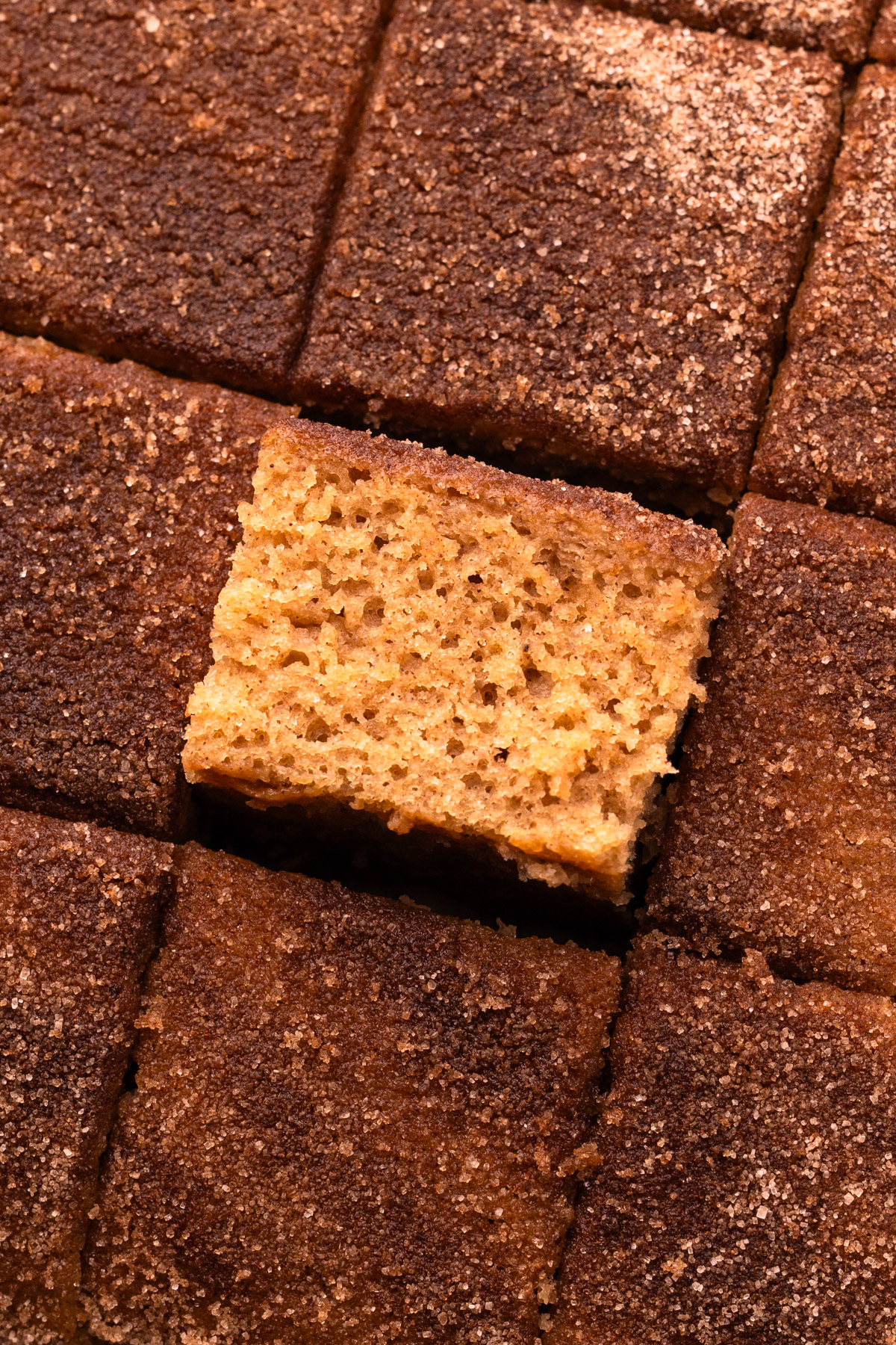 Square slices of baked cake, with one slice turned on its side to see the fluffy interior.