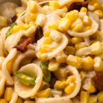 A close up of the creamy corn pasta with bacon in a bowl.