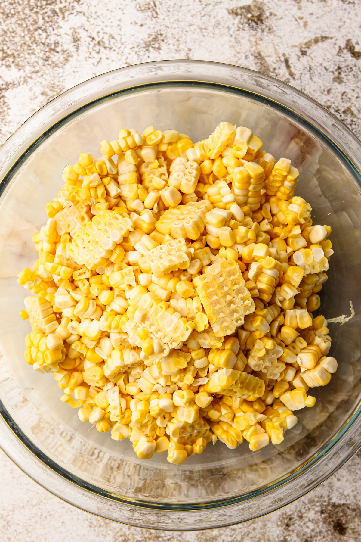 A bowl of cut up corn from corn cobs.