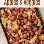 A sheetpan of roasted kielbasa, vegetables, and apples.