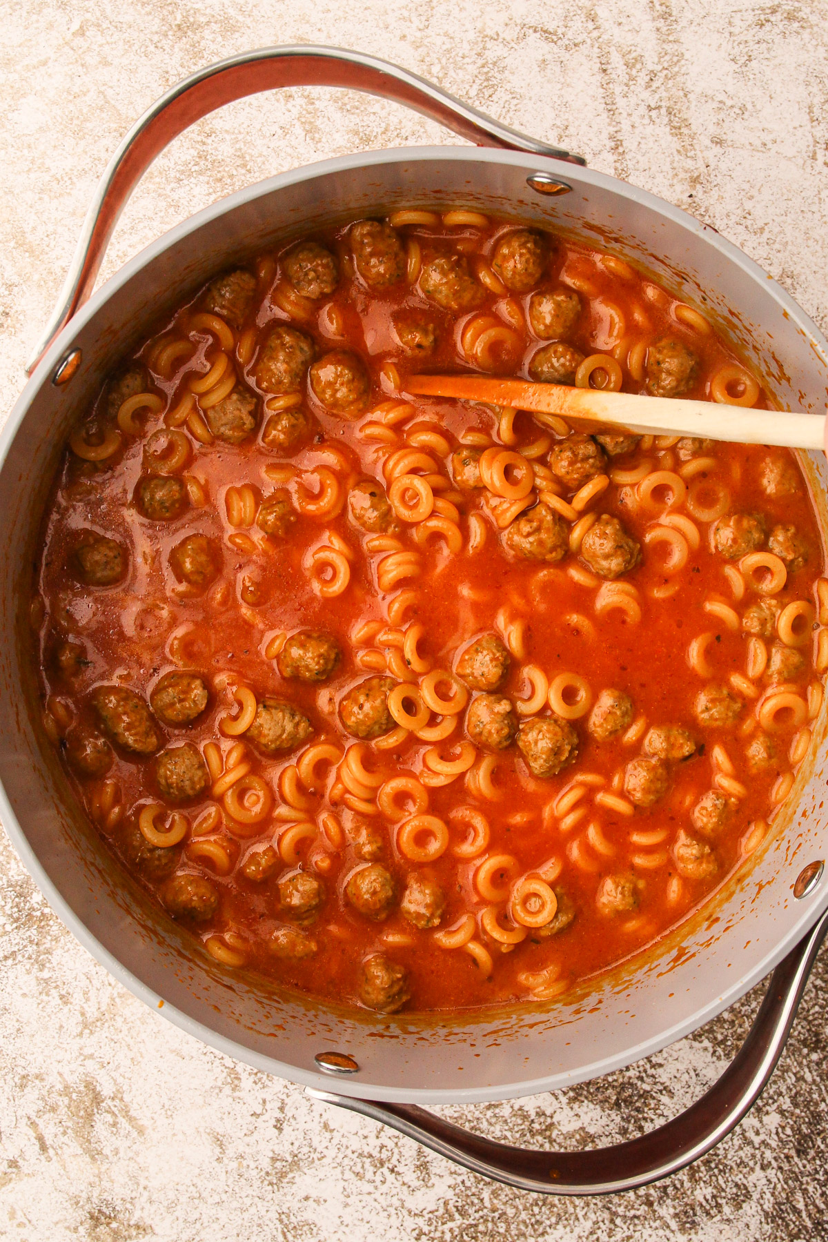 A pot with prepared homemade spaghettio and meatballs.