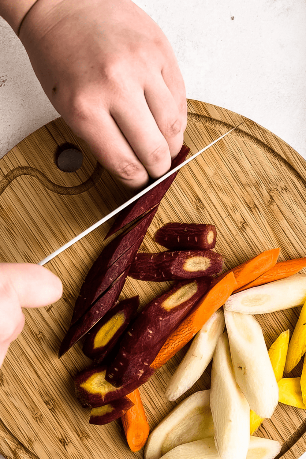 Cutting carrots on the bias for roasted carrots.