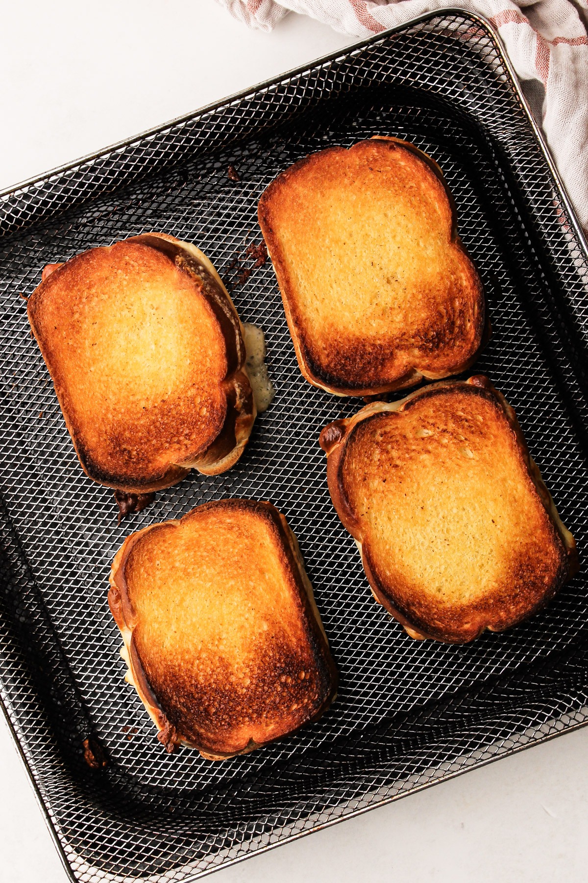 Cooked air fryer grilled cheese sandwiches.