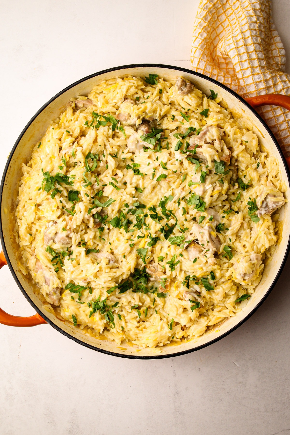 Creamy lemon chicken orzo pasta with zucchini and herbs.