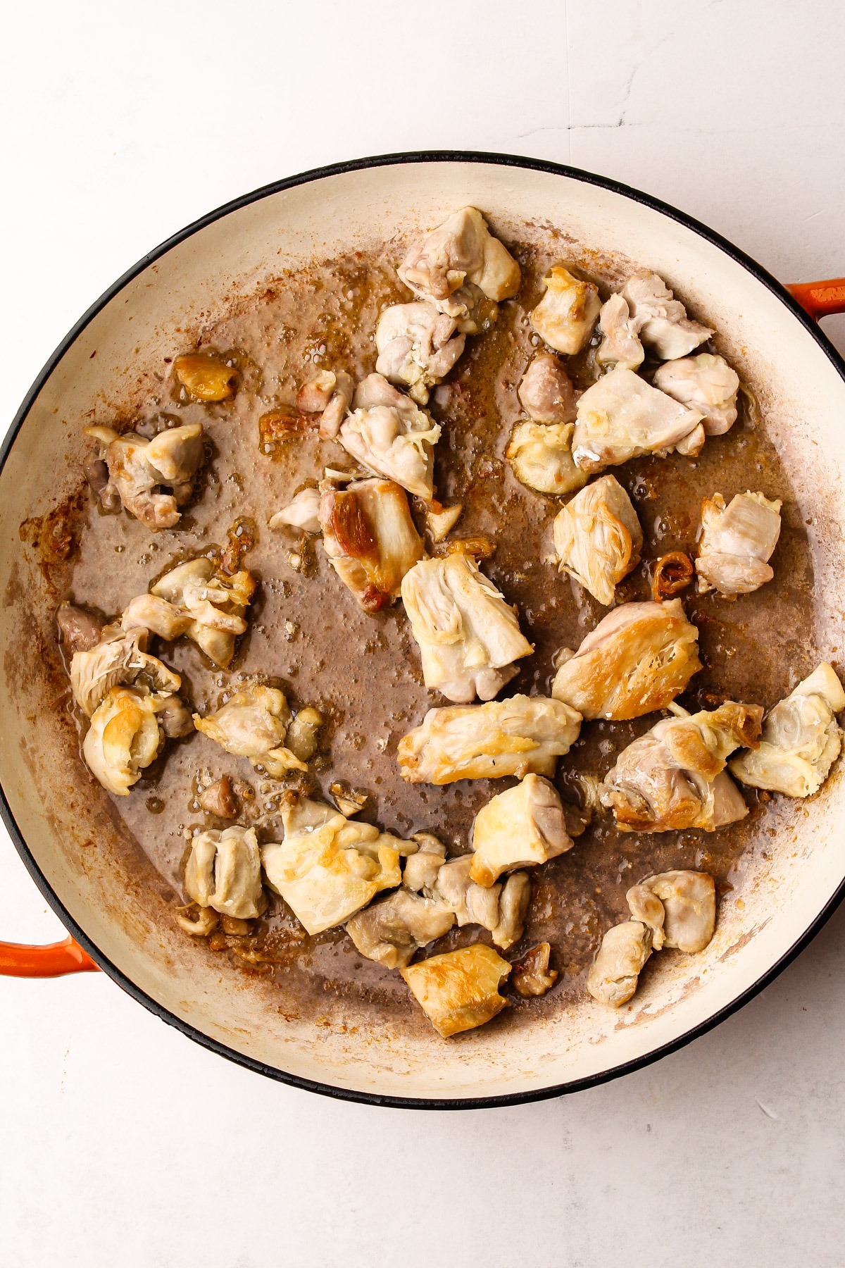 Browning chicken in a skillet.