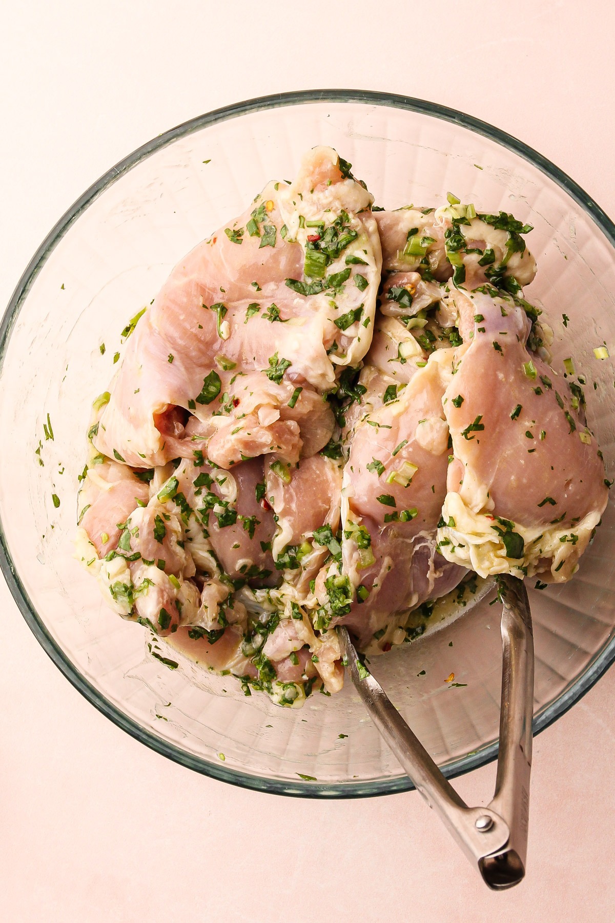 Coating the chicken in the cilantro lime marinade.