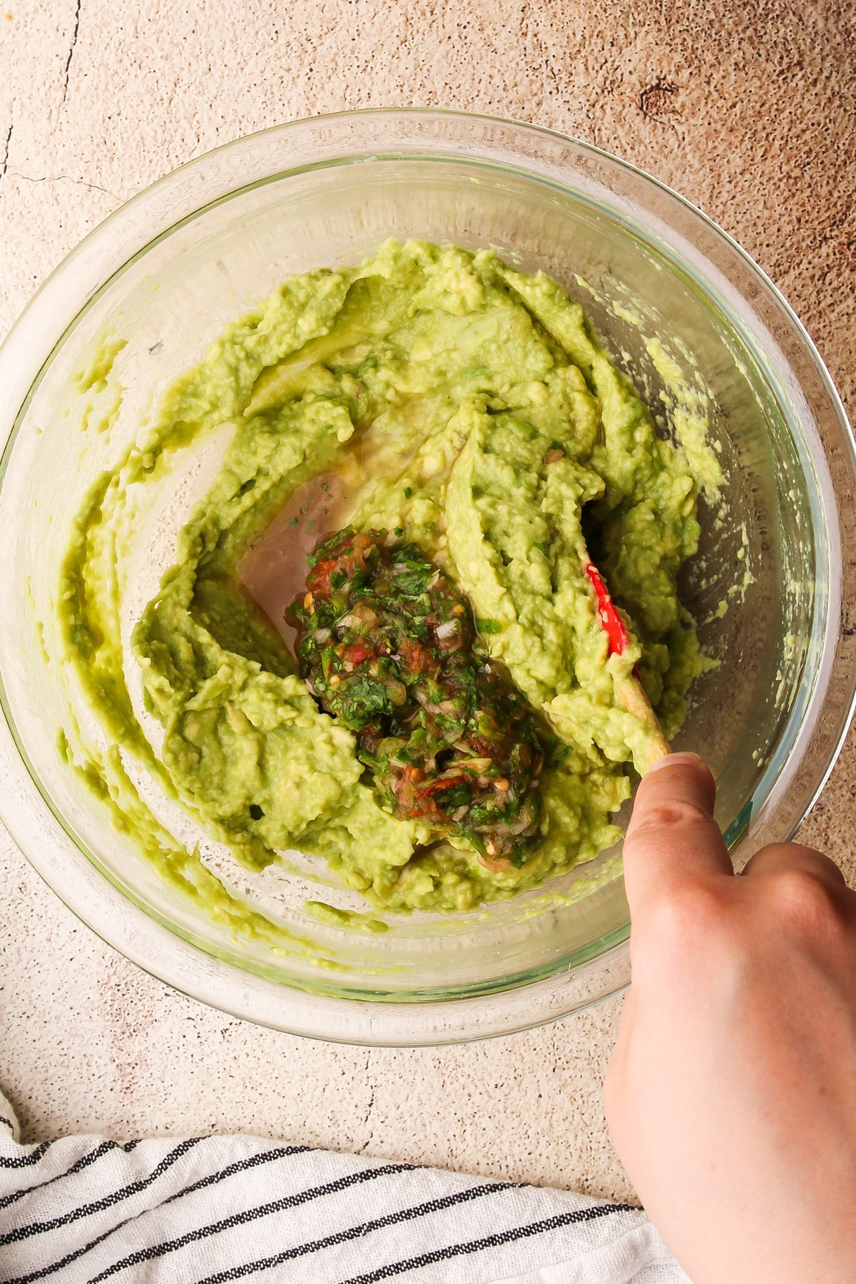 Stirring in aji into guacamole.