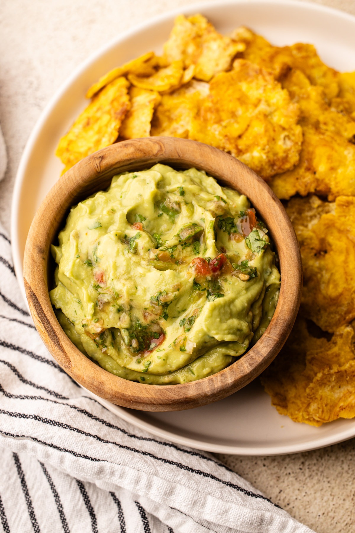 Colombian guacamole in a bowl served with tostones.