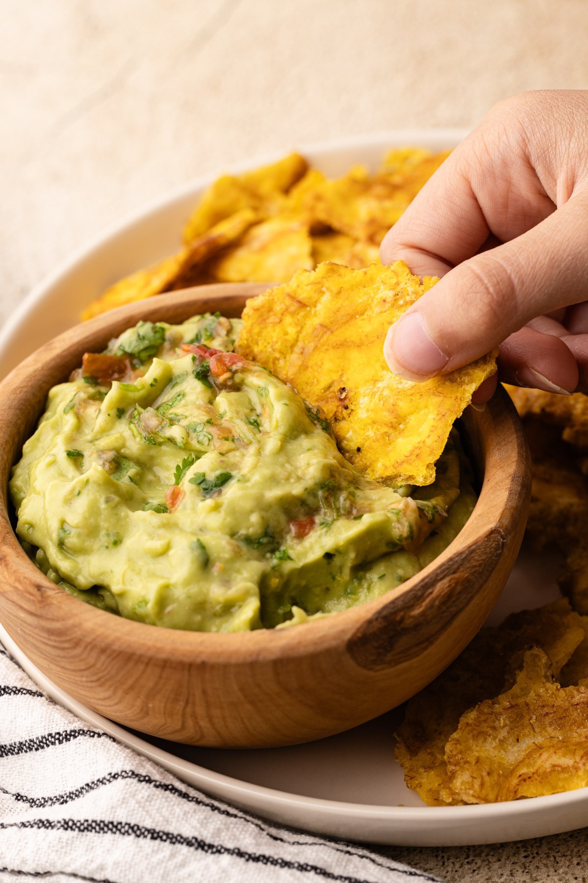 Dipping a chip in a bowl of Colombian guacamole.